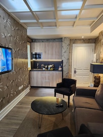 Kitchenette with fridge, dishes, bottled water, tea kettle and coffee maker. Coffee pods provided.