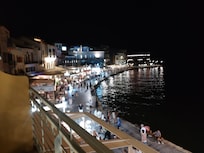 Harbor at night to the left of hotel balcony