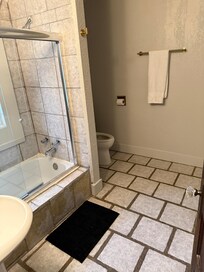 Bathroom well maintained with linens