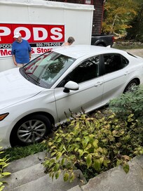 Parking was tight because of overgrown plants and storage unit.