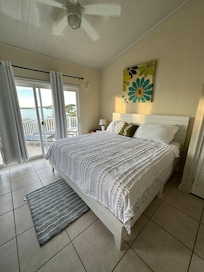One of the 2 bedrooms with a patio door directly to the pool.