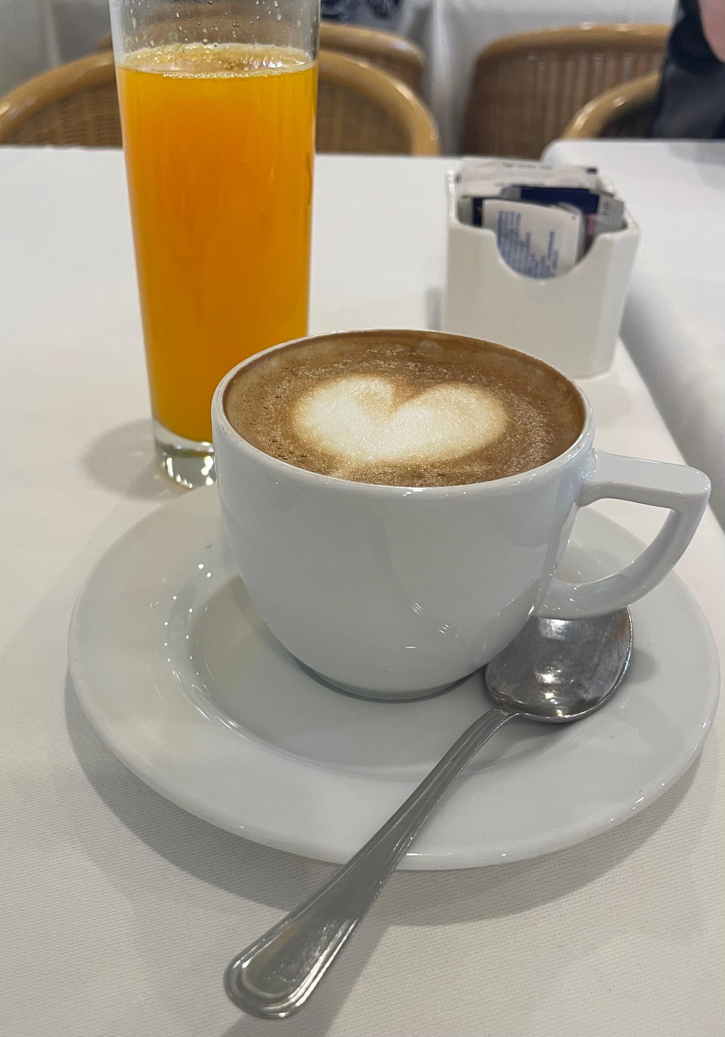 Freshly squeezed juice and cappuccino at breakfast 