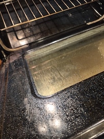 Kitchen oven with accumulated "gunk" from previous renters.