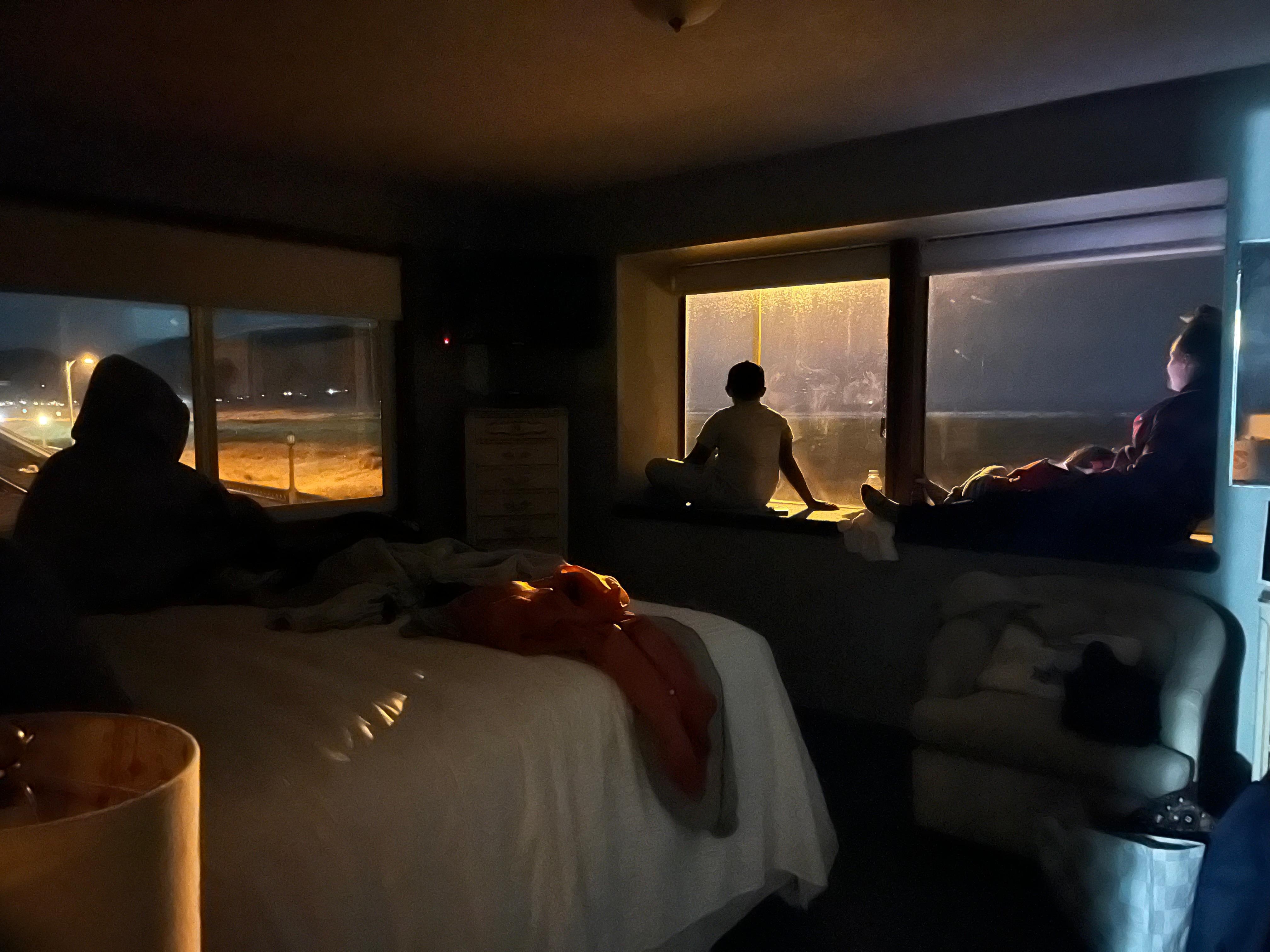 The family looking out the window in the evening and just relaxing together.