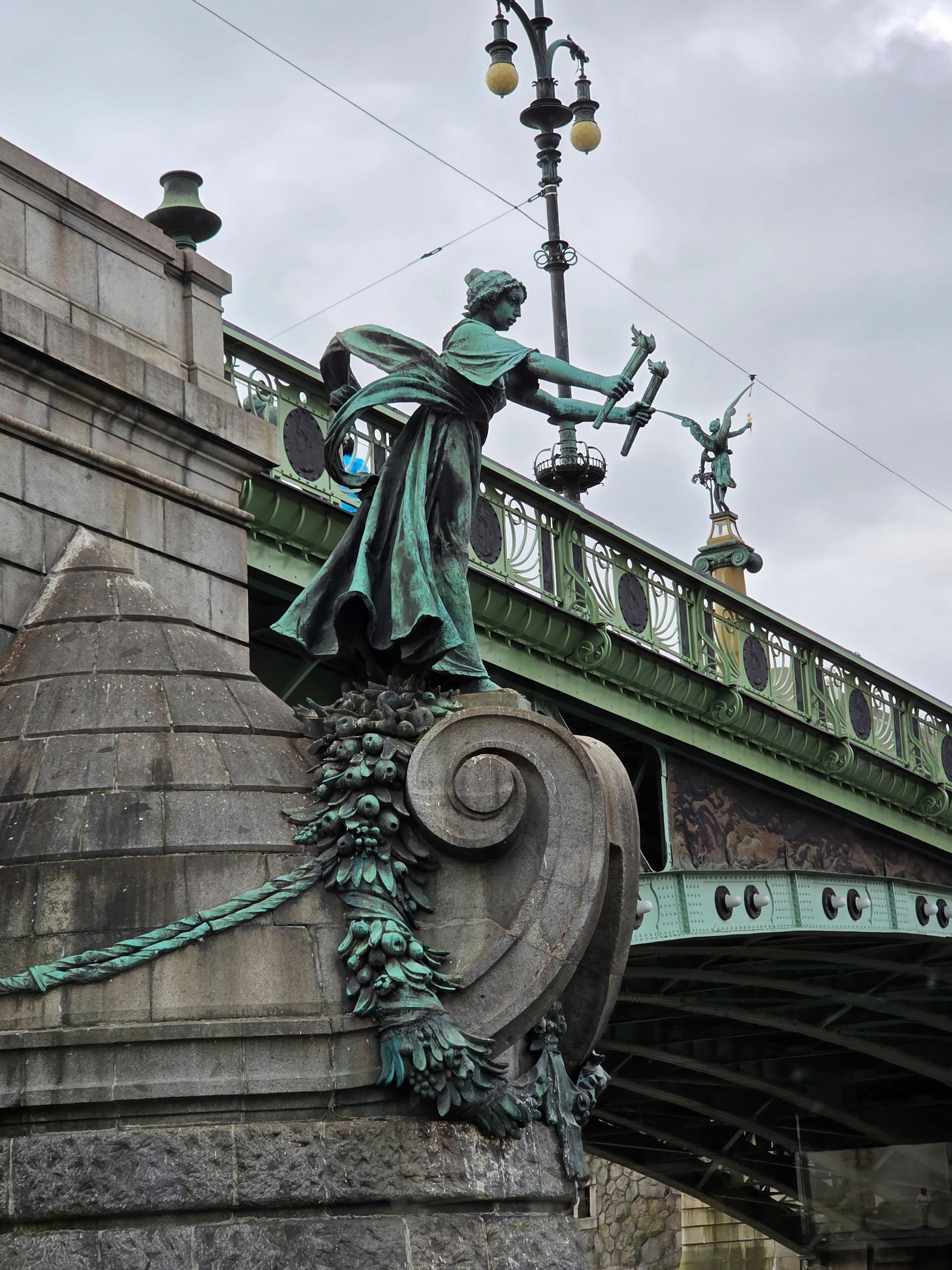 Statue next to river. 