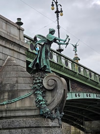 Statue next to river.