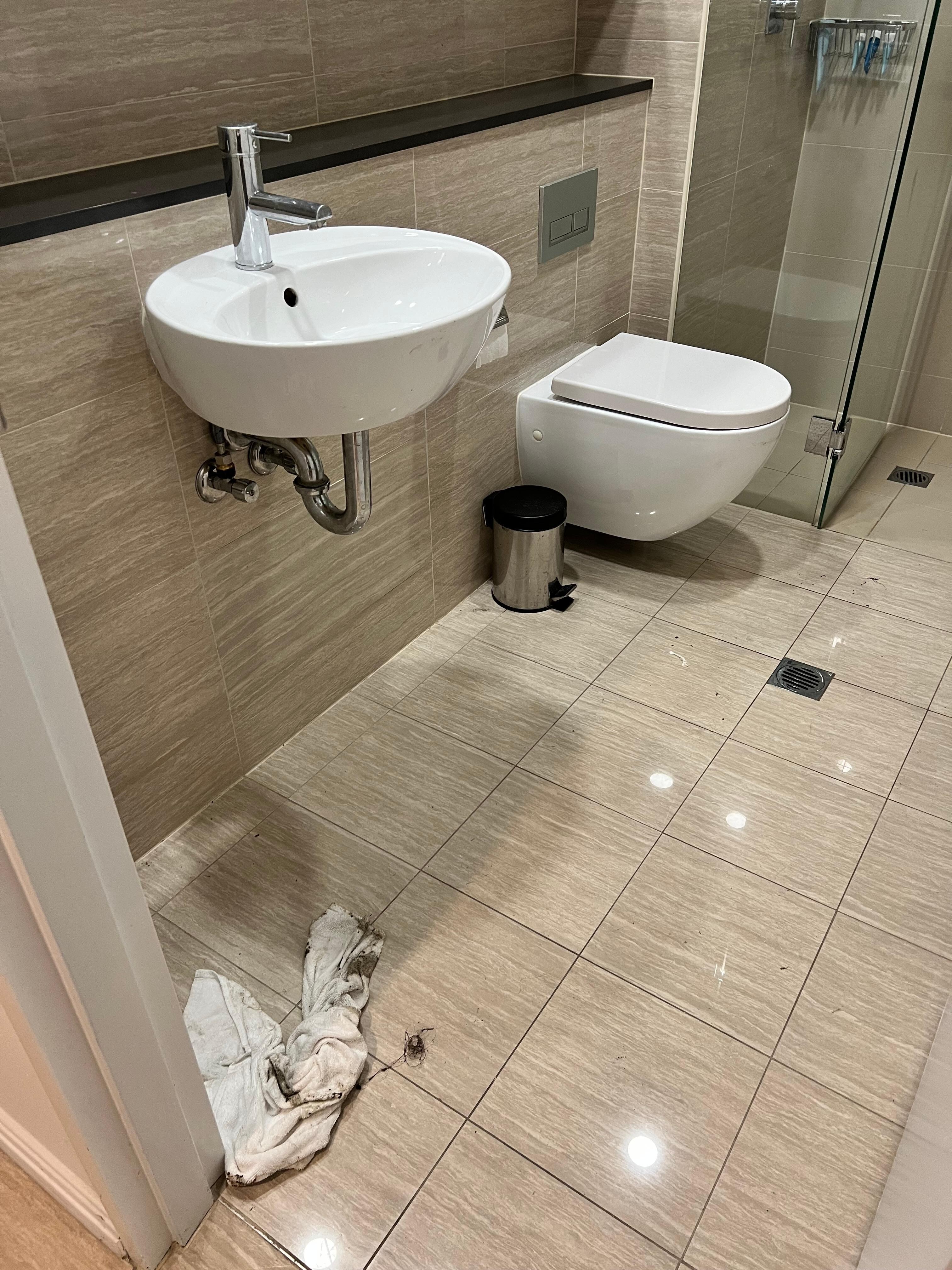 Toilet floor unclean after servicing.