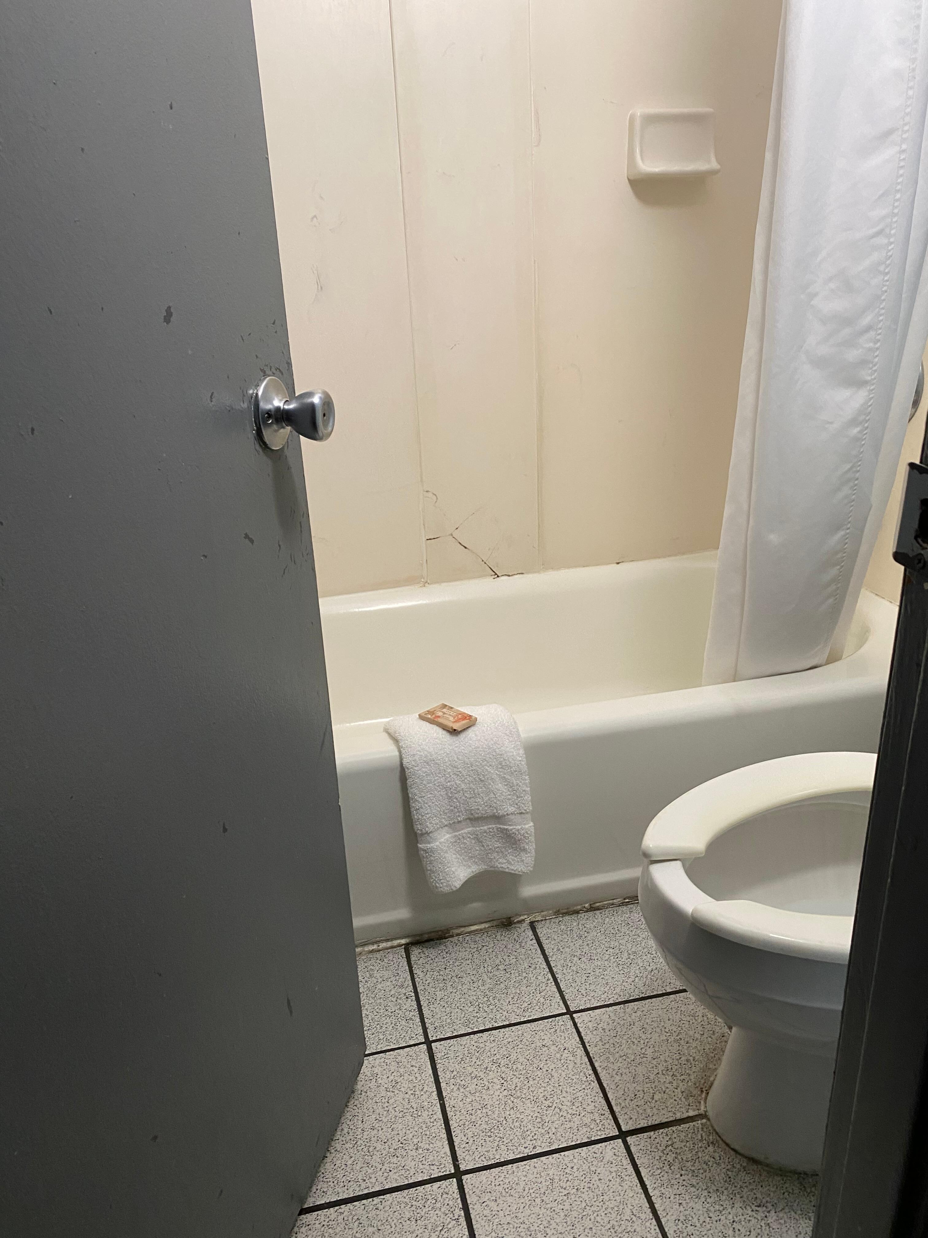 Bathroom was extremely small, tile cracked and the faucet area rusted and in need of repair