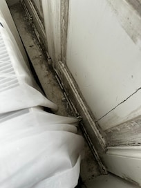 Dirty floor down the side of the bed