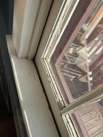 dirty windowsill with peeling paint