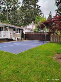 Outside backyard! Pickle ball and basketball hoop made our two grandsons very happy! All the equipment was there to play too!
