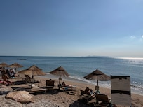 View of coral beach, chairs and umbrella use included as amenity for guests