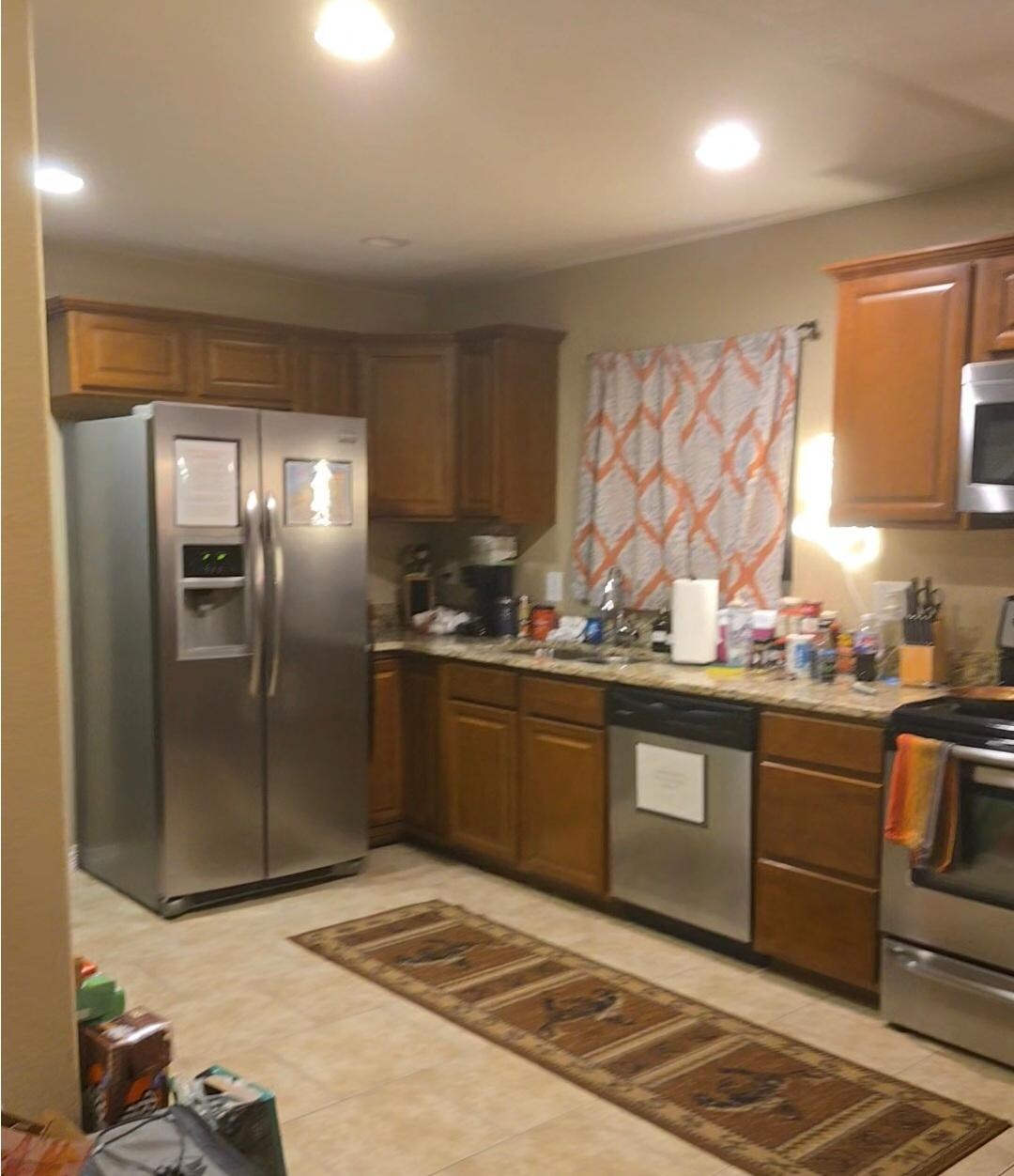 Kitchen with full fridge and water ice maker combo. Spacious peninsula was not shown in photo next to the stove