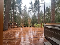Outdoor deck area with hot tub.