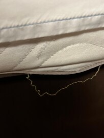 Torn mattress in room