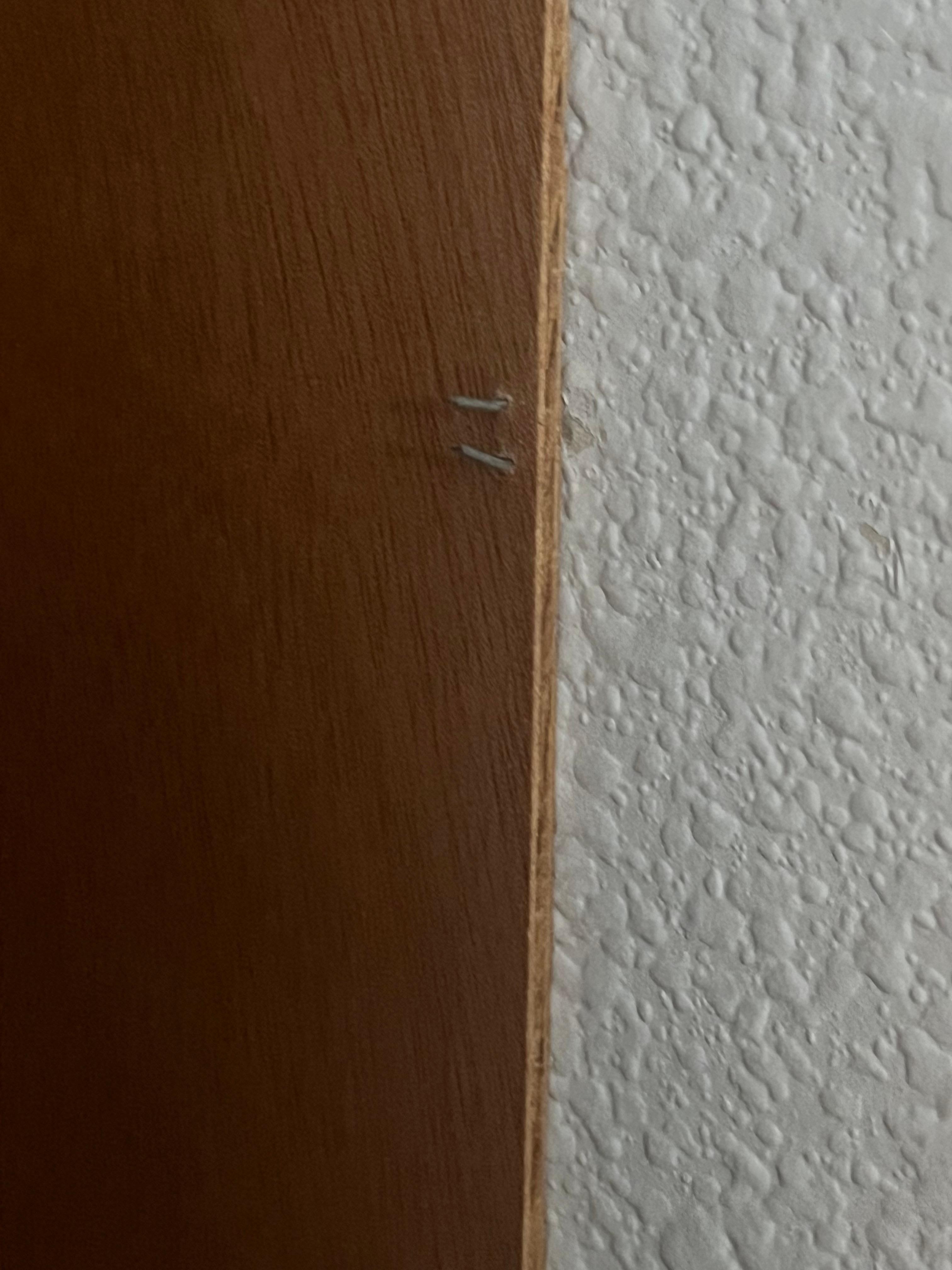 Exposed staples right near light switch