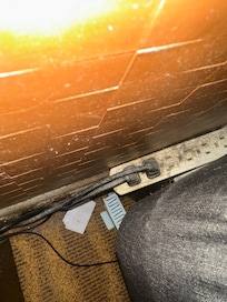 Between bedside table and bed