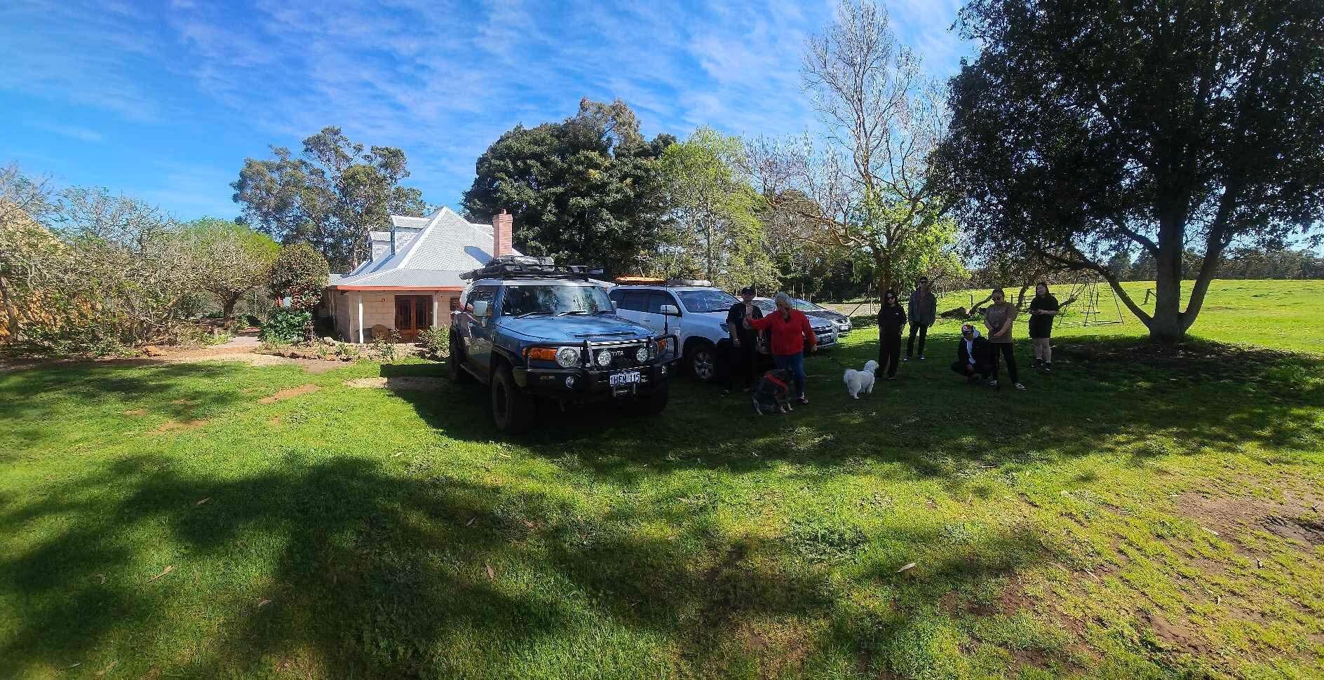 The facade, with the family and farmhouse in the background