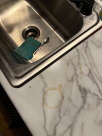 Coffee rings on counter, dirty spoon and sponge in sink, 1/3 full pot of cold coffee (not shown- limited to 8 photos)