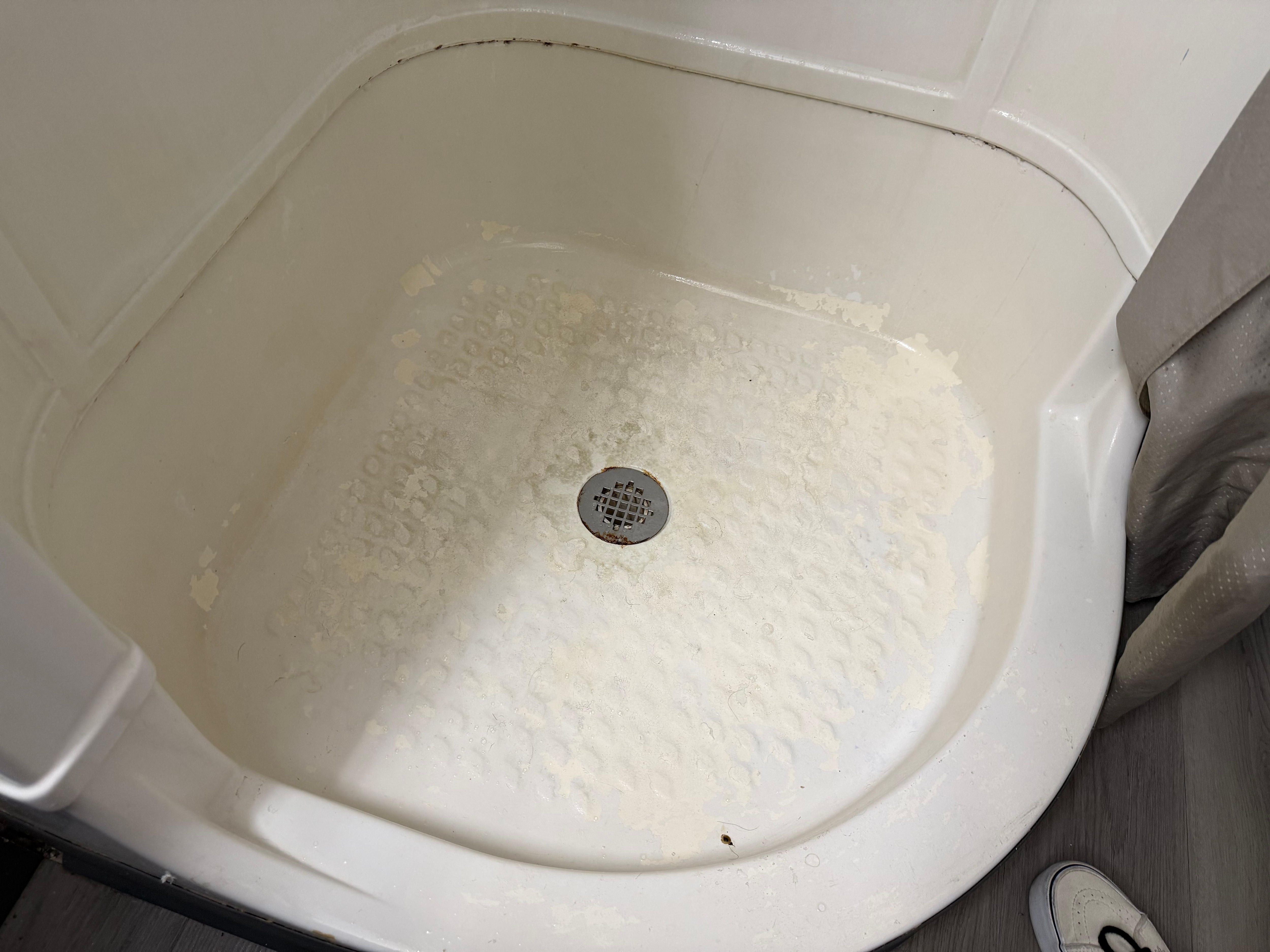 Calcium/Lime Buildup in shower 
Rm 125