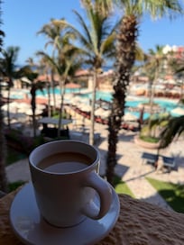 Coffee and pool view from balcony