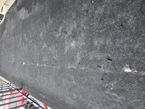 This is the carpet just outside of our room. Dirty and worn and has holes that show the concrete underneath it