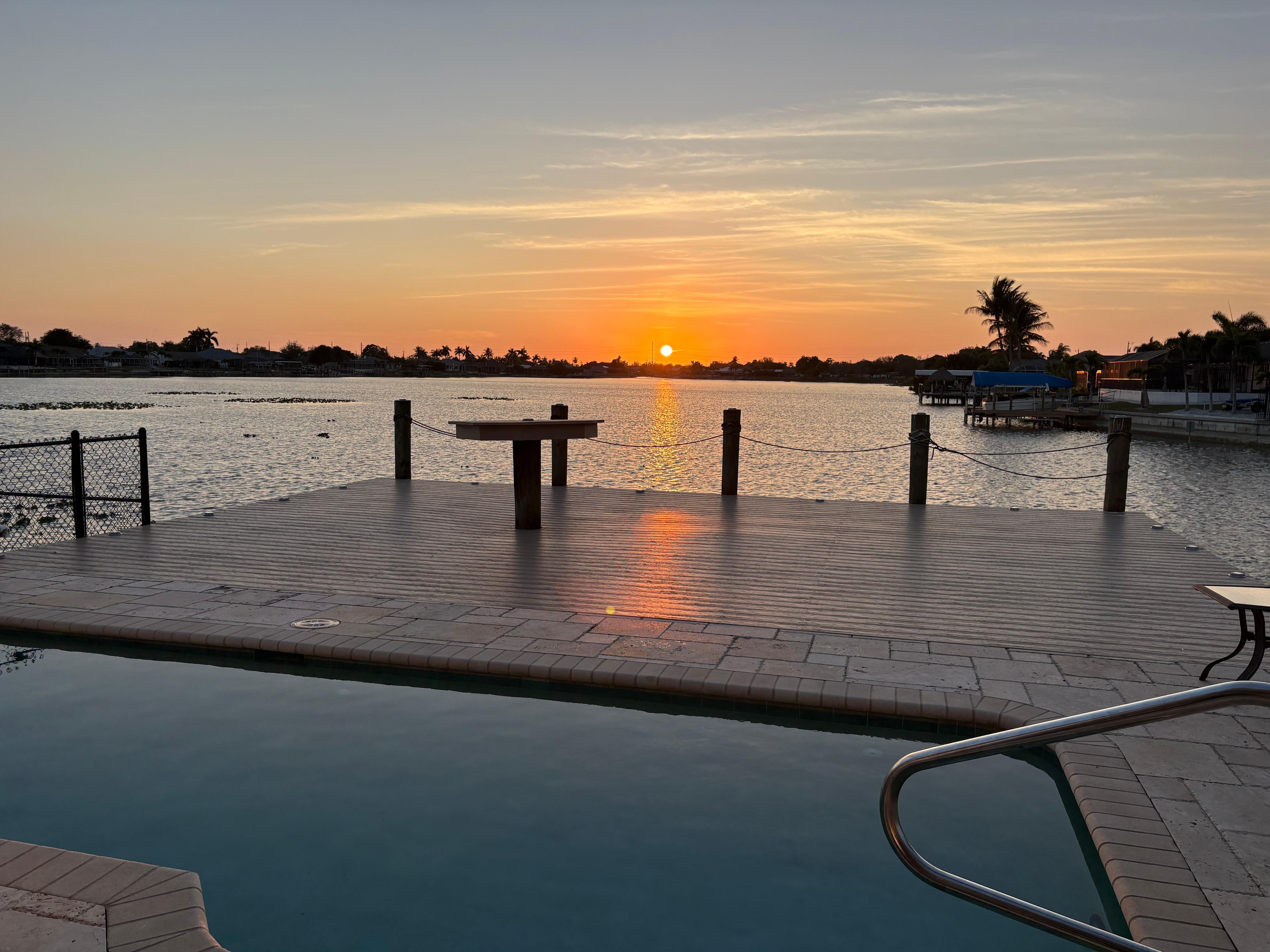 Pool and deck on lake. 