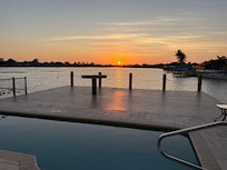 Pool and deck on lake.
