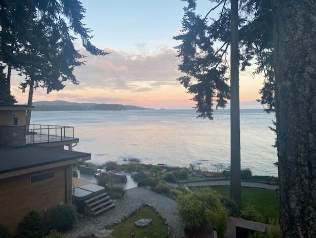 View from the cottage deck looking across at main house at sunset.