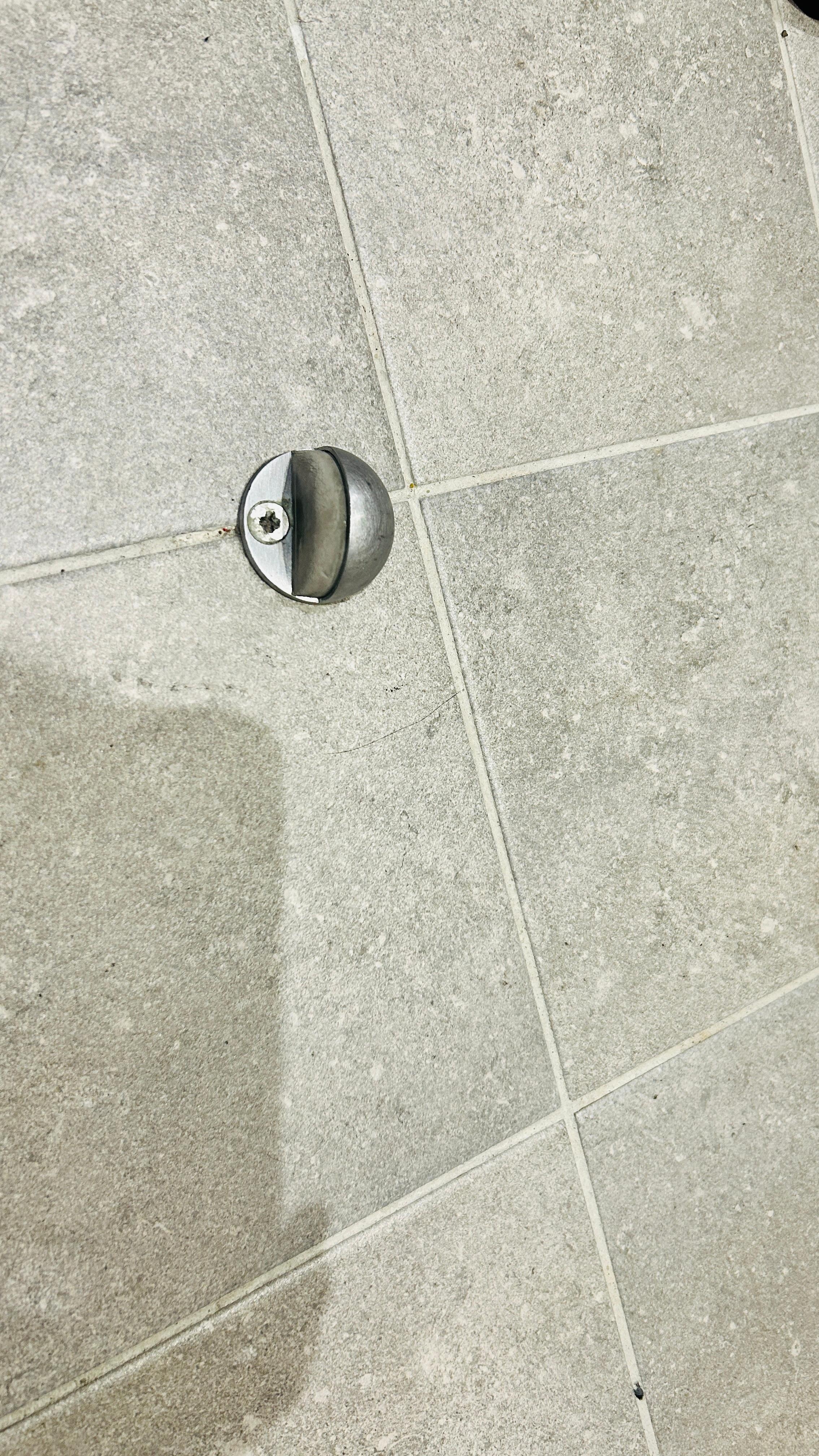 Door stop on floor which is a trip hazard. 