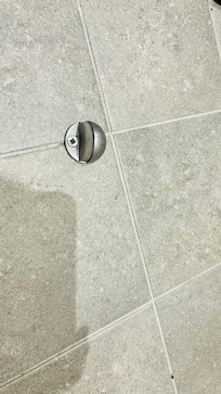 Door stop on floor which is a trip hazard.