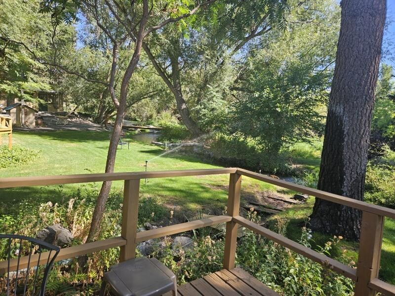 Out the back sliding door, is the small yard next to the creek.