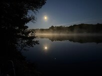 Harvest Moon over the lake on a cool morning