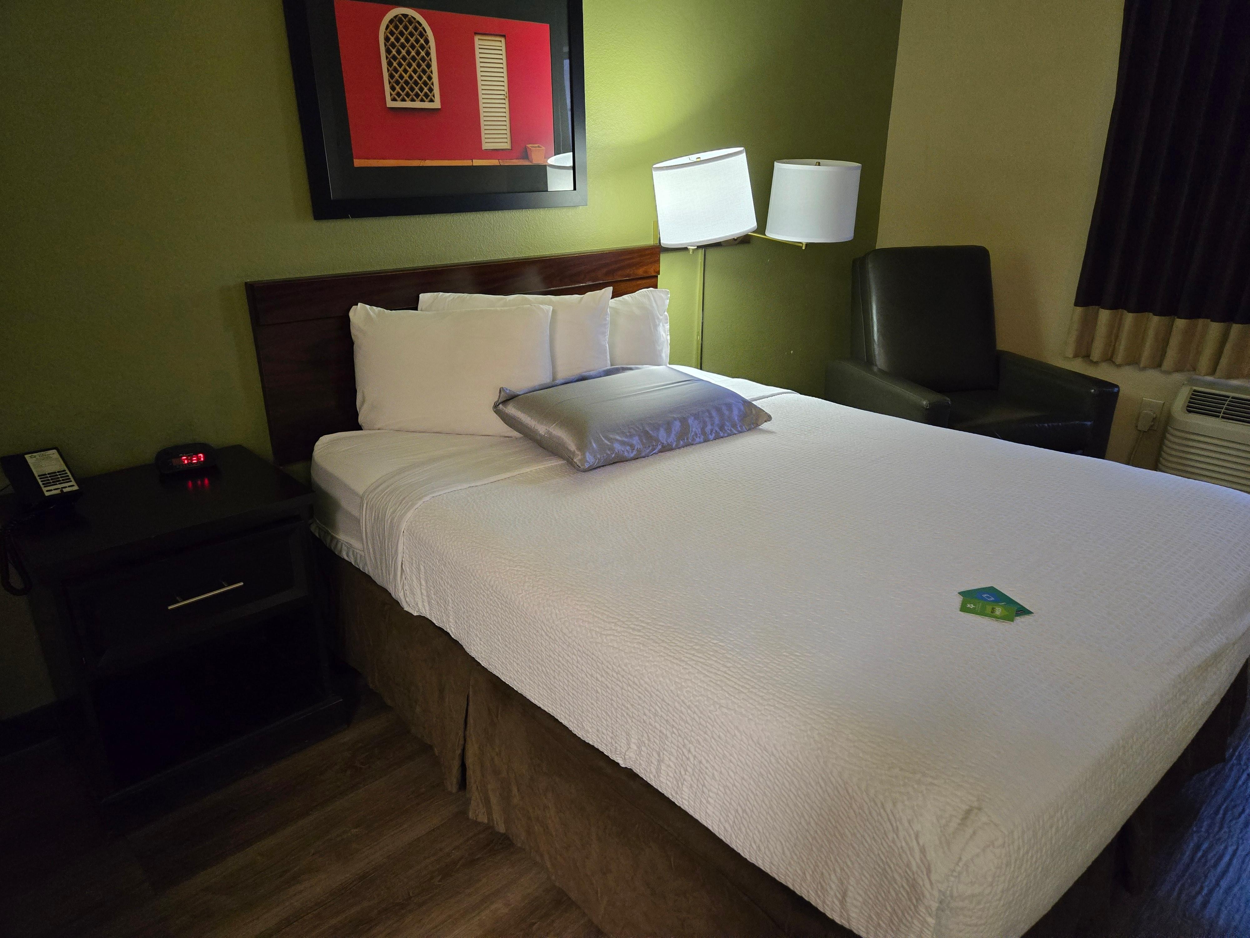 Comfy queen size bed with three pillows