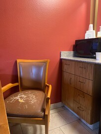 Both chairs at this kitchen table need to be replaced or reupholstered.