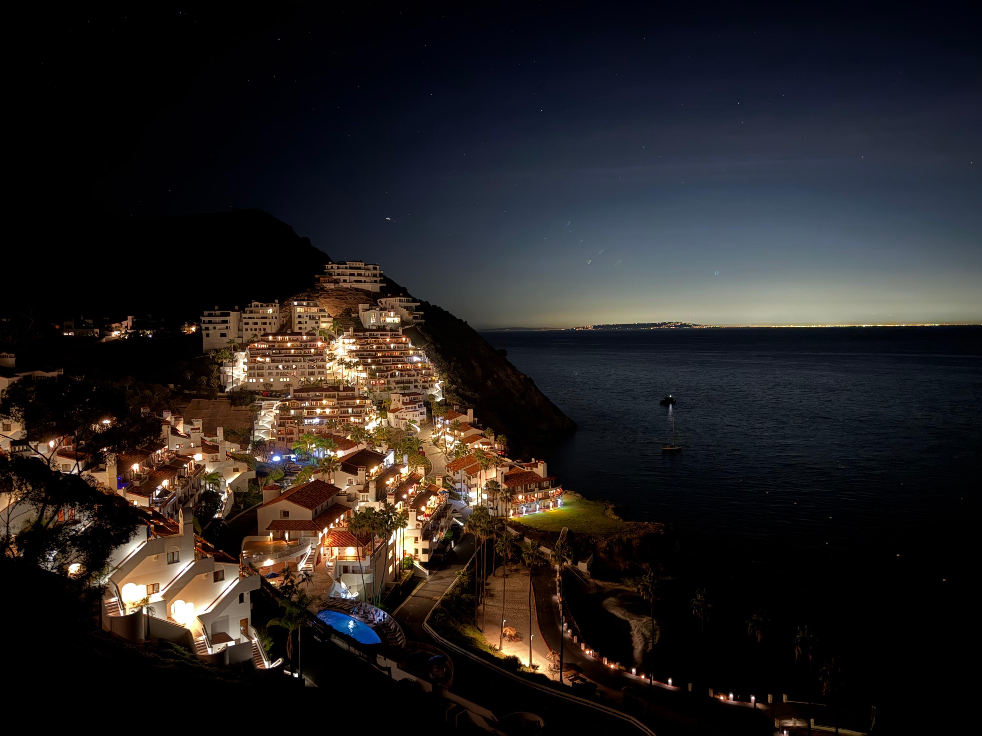 Nighttime vista from golf cart looking down on the resort. 