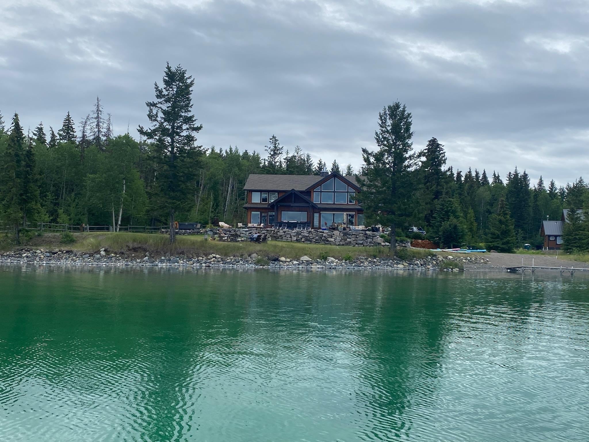 Paddle boarding was a favorite activity. Water is clear!  View of house from lake. 