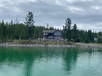 Paddle boarding was a favorite activity. Water is clear! View of house from lake.