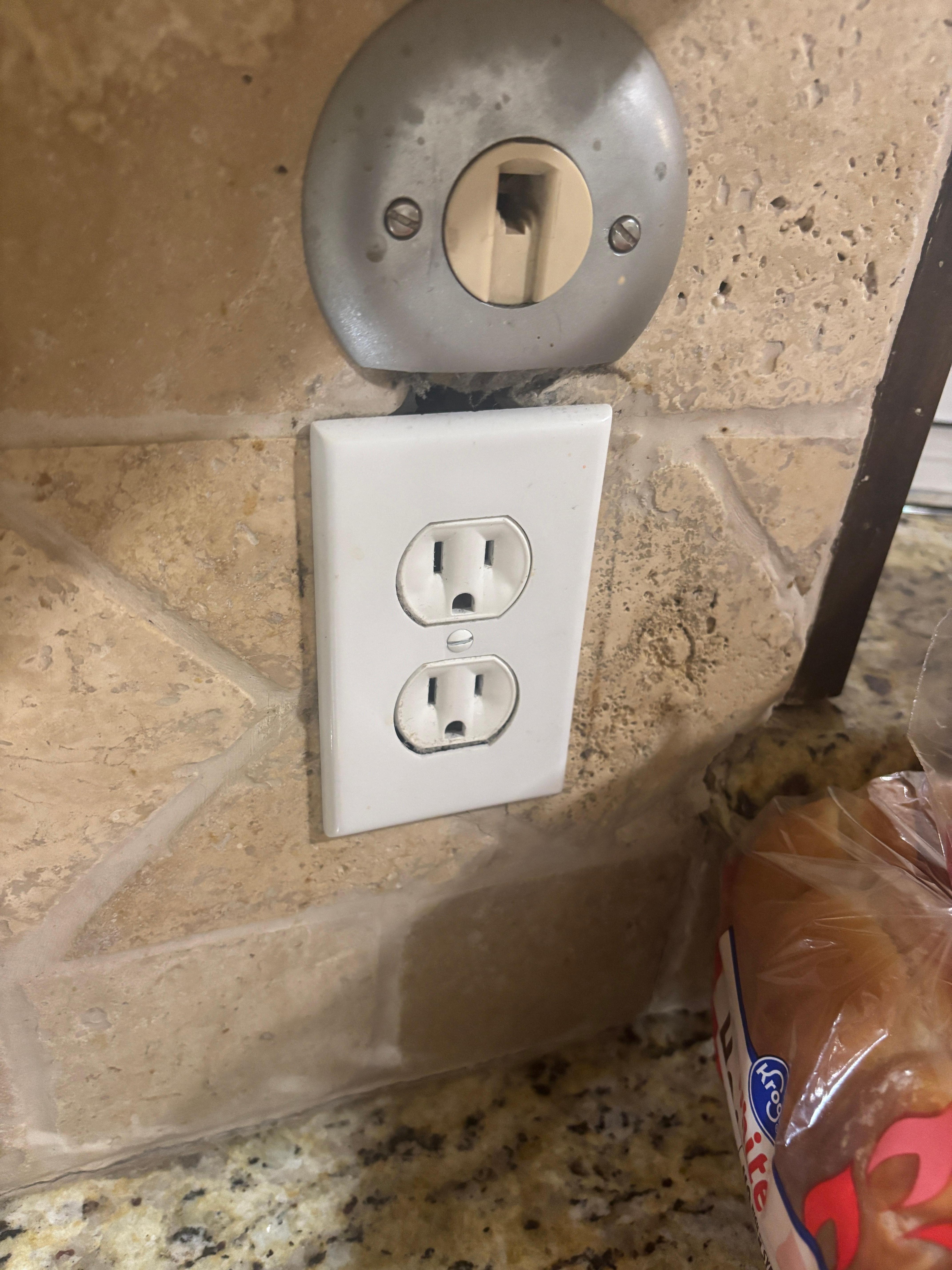 Damaged wall and outlet. 
