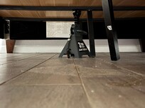 The bed is broken and being held up with a jack