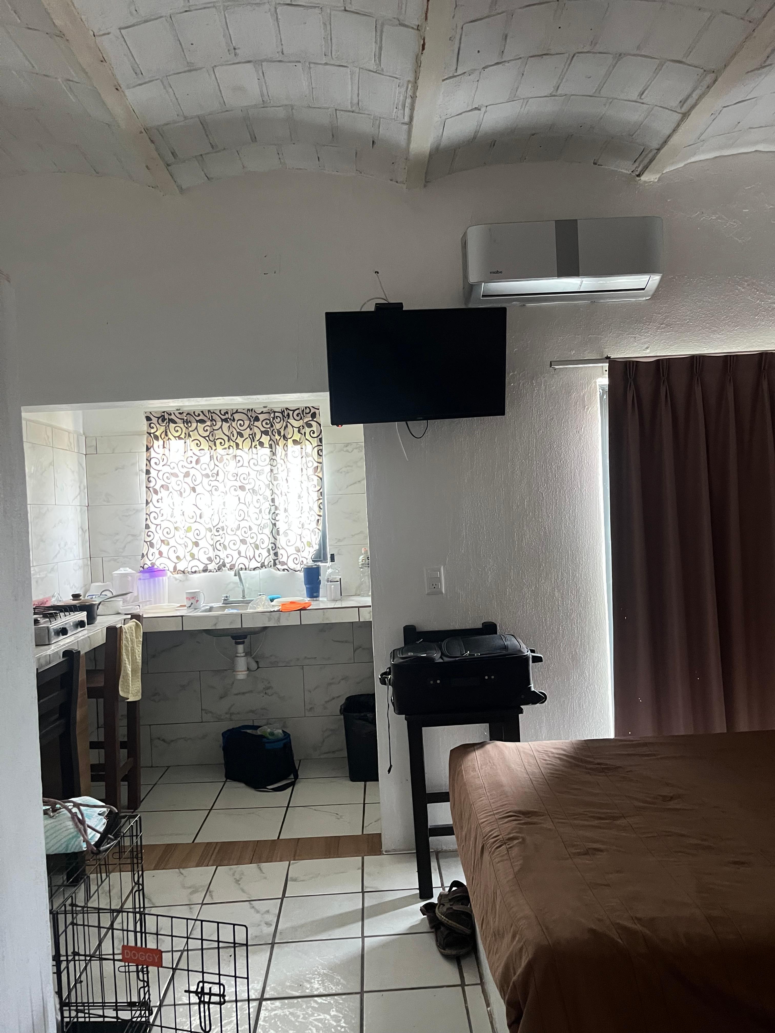 This picture shows the air conditioner and a tv in the room