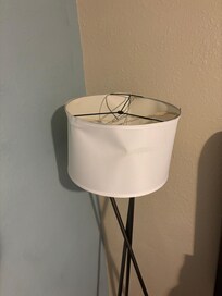 Torn lamp shade and broken lamp