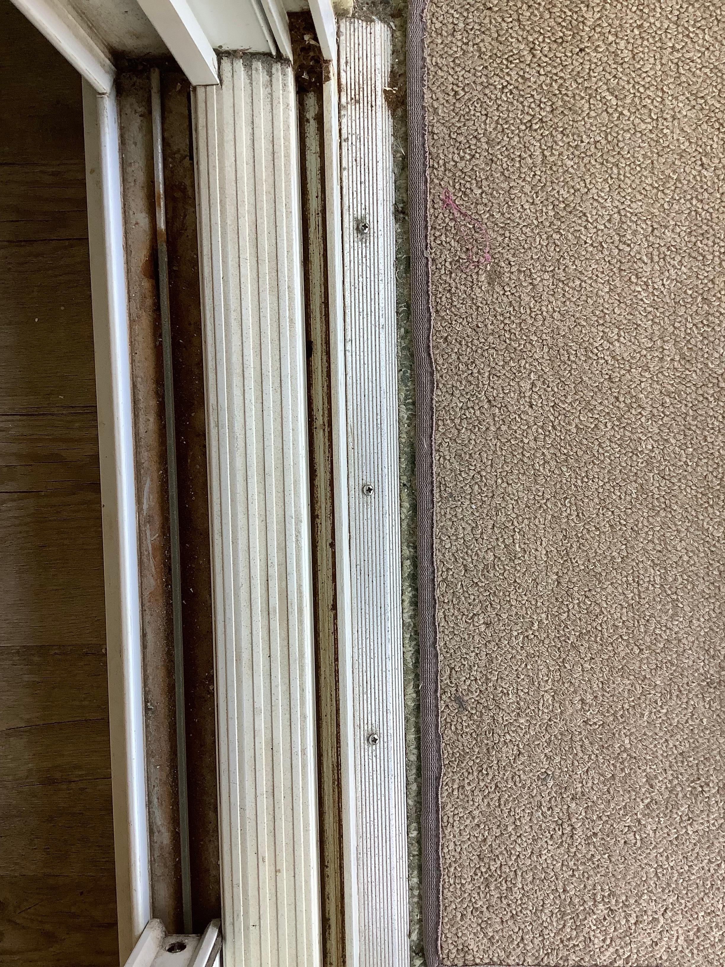  Caked  on  grime and dirt on both sides of sliding glass doors 