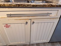 Water damage on almost all cabinets in the kitchen.