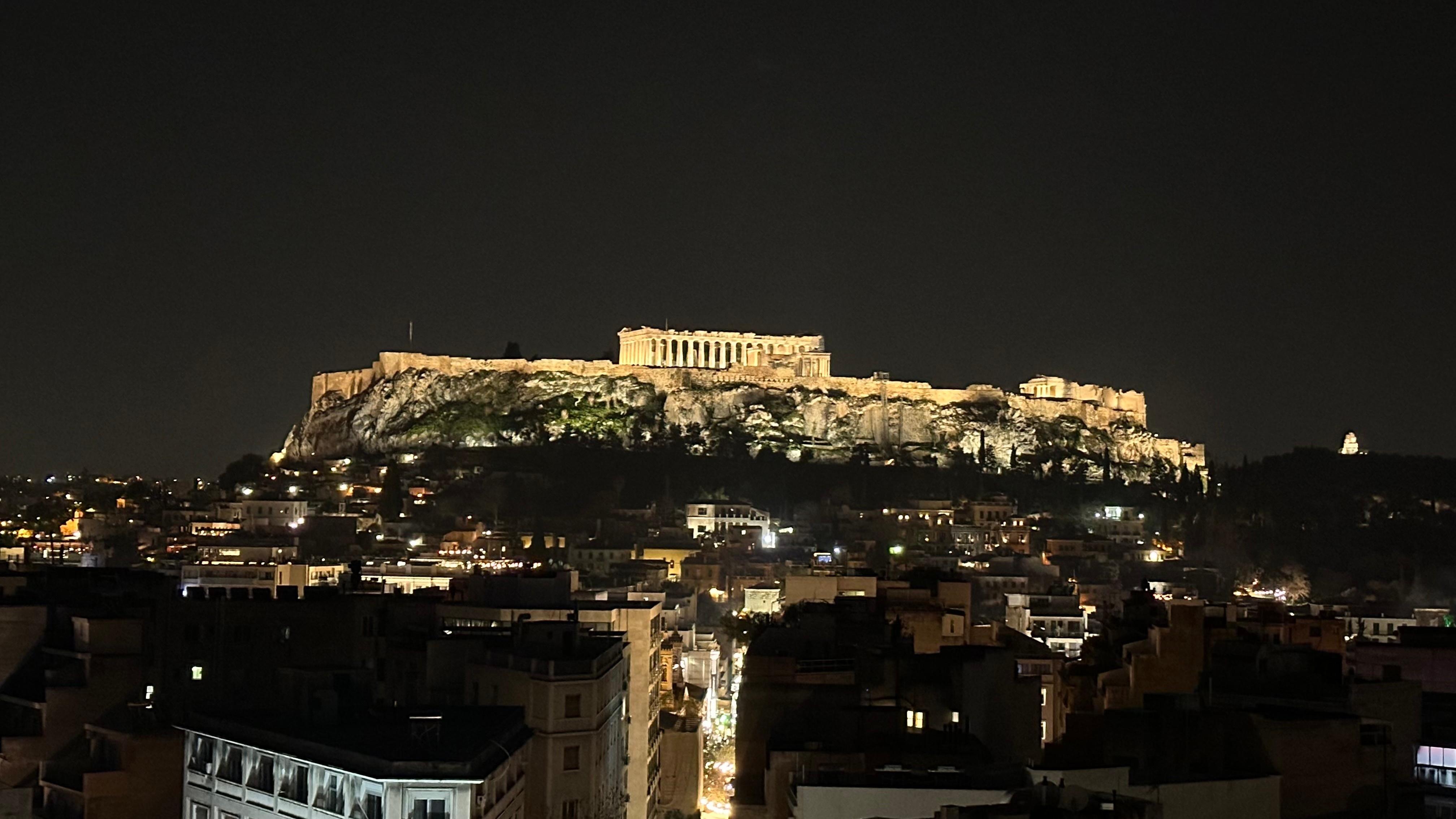Acropolis at night seen from rooftop desk.   