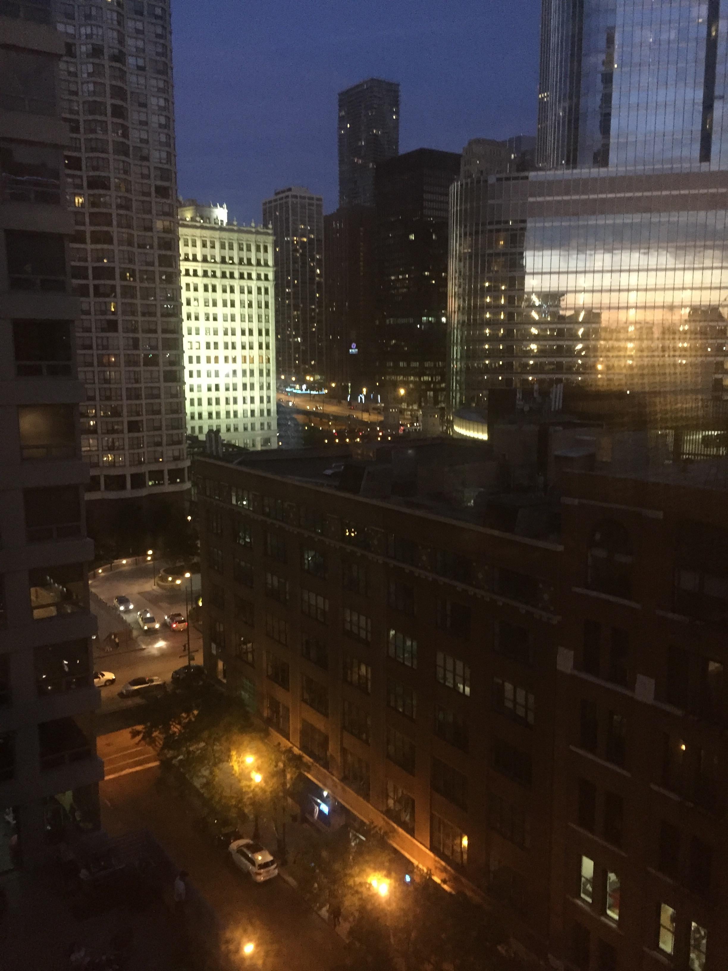 Nighttime view of nearby Trump Tower and the Chicago River in the background.