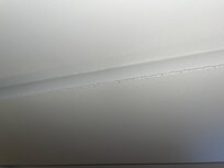 A thick layer of dust on the ceiling opposite the air vent.