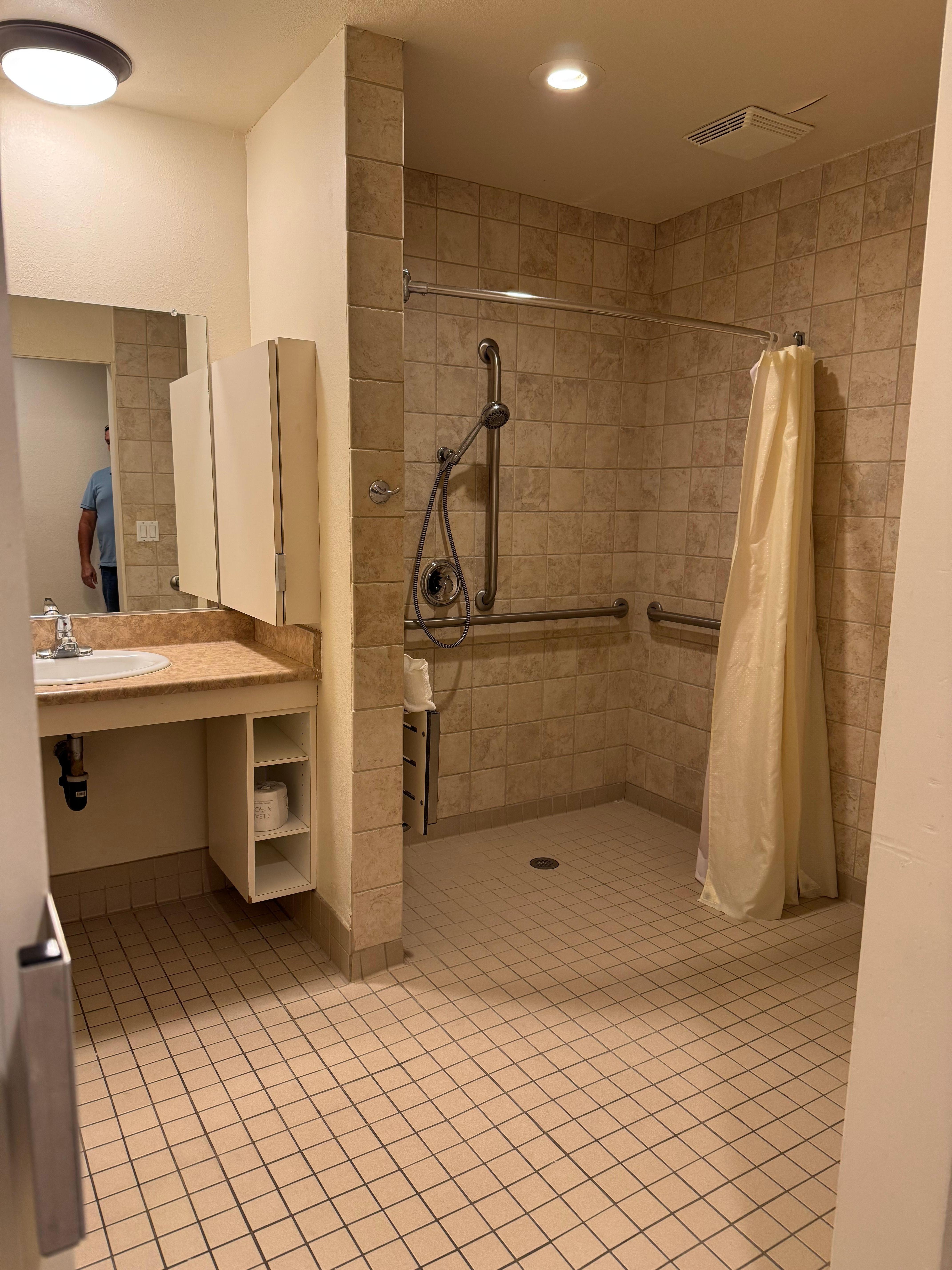 Very large handicap accessible bathroom with fold up seating