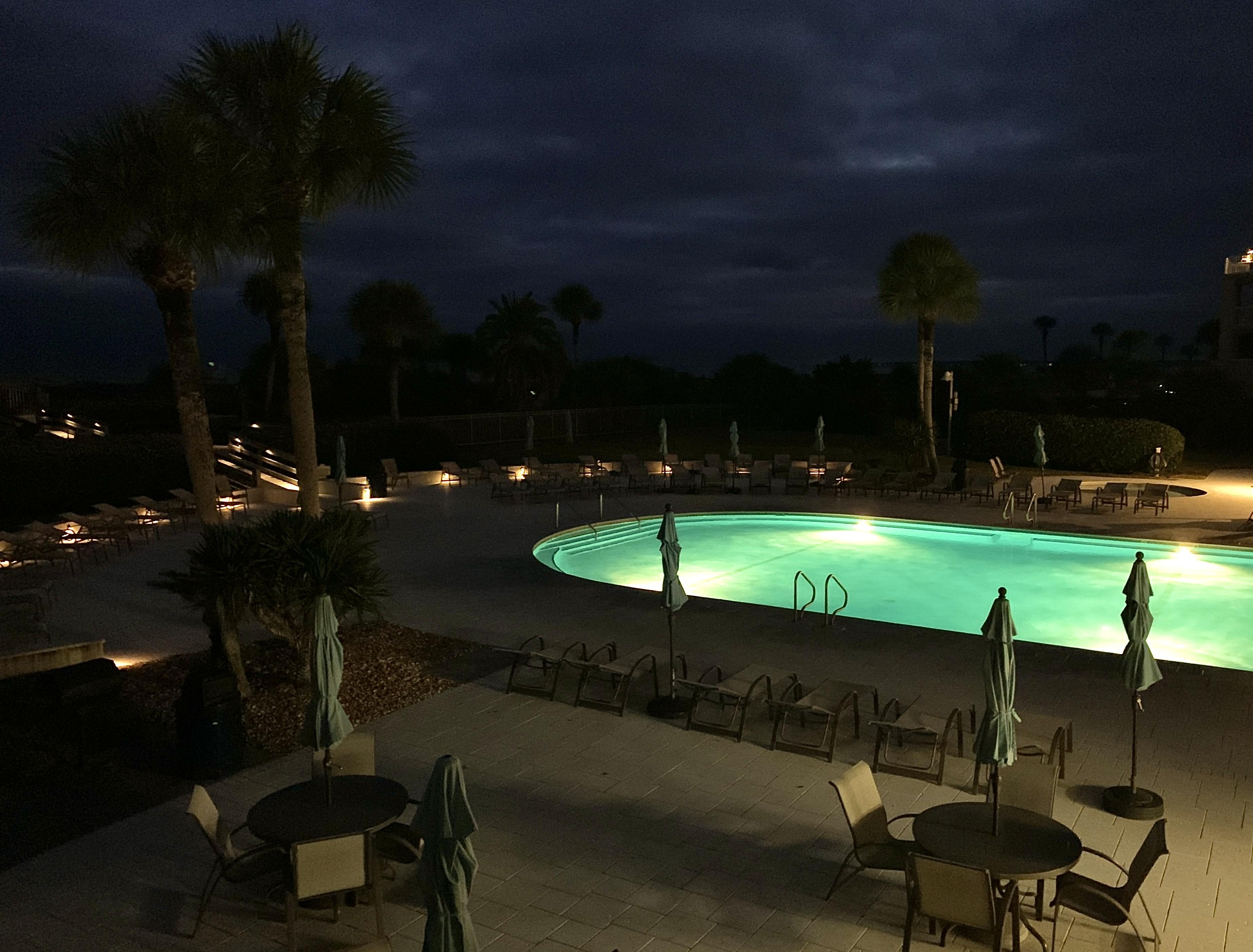 View of pool from balcony at night