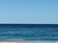 The crystal clear cerulean water steps from the pool and lanai